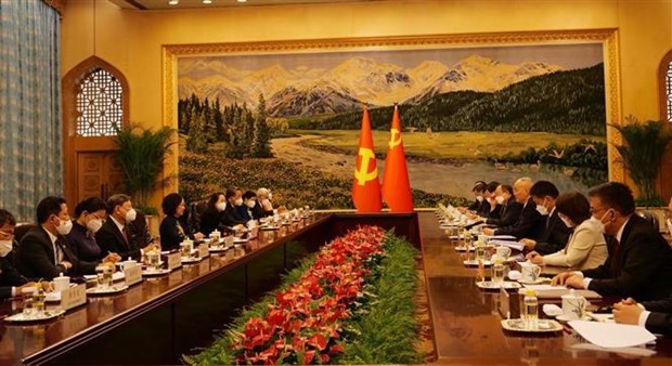 At a meeting between representatives of the two Politburos (Photo: VNA) At a meeting between representatives of the two Politburos (Photo: VNA)