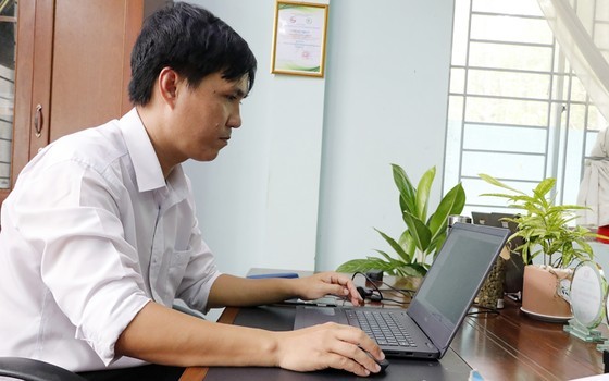 Bui Nguyen The Kiet is monitoring the status of Can Gio forest via his software in his office Bui Nguyen The Kiet is monitoring the status of Can Gio forest via his software in his office