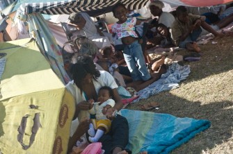 A woman feeds her child under makeshift tents across the street from the presidential palace in Port-au-Prince on January 14, 2010, two days after an earthquake measuring 7.0 on the open-ended Richter scale hit the Haitian capital. (Photo: AFP) A woman feeds her child under makeshift tents across the street from the presidential palace in Port-au-Prince on January 14, 2010, two days after an earthquake measuring 7.0 on the open-ended Richter scale hit the Haitian capital. (Photo: AFP)