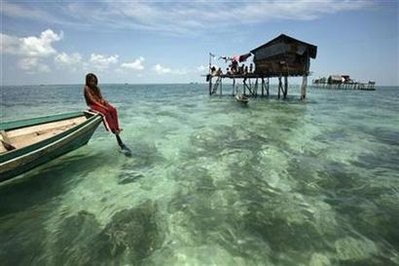 A Bajau Laut girl basks on her boat in her neighbourhood in Sulawesi Sea in the Malaysia's state of Sabah on the Borneo island February 17. A Bajau Laut girl basks on her boat in her neighbourhood in Sulawesi Sea in the Malaysia's state of Sabah on the Borneo island February 17.