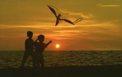 Along with the flying kites are the hopes and aspirations of young children Along with the flying kites are the hopes and aspirations of young children