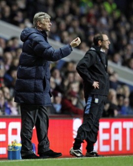 Arsenal manager Arsene Wenger (L) gestures next to Aston Villa manager Martin O'Neill during the English Premier League football match between Aston Villa and Arsenal at Villa Park in Birmingham, England on January 27, 2010. AFP PHOTO