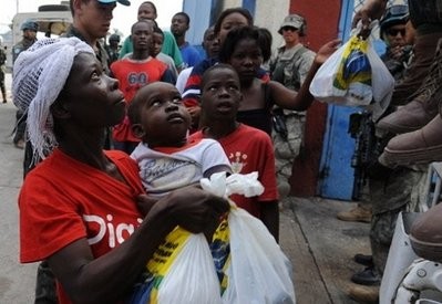 Haitians are given aid at a distribution point in Port-au-Prince on January 31, 2010. AFP photo Haitians are given aid at a distribution point in Port-au-Prince on January 31, 2010. AFP photo