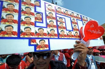 A supporter holds a banner showing ousted former premier Thaksin Shinawatra during a protest at the Defence Ministry in Bangkok on February 2, 2010. AFP photo A supporter holds a banner showing ousted former premier Thaksin Shinawatra during a protest at the Defence Ministry in Bangkok on February 2, 2010. AFP photo