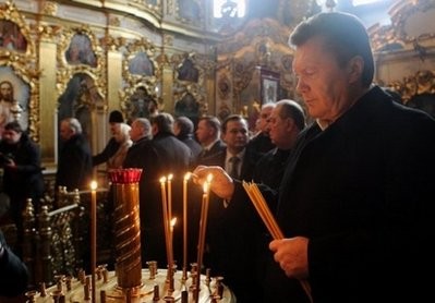 Ukraine Regions Party presidential candidate Viktor Yanukovich lights a candle during a prayer service in Kiev. Ukraine Regions Party presidential candidate Viktor Yanukovich lights a candle during a prayer service in Kiev.