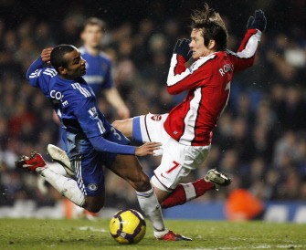 Chelsea defender Ashley Cole (L) is tackled by Arsenal midfielder Tomas Rosicky (R) during their English Premier League football match against Arsenal at Stamford Bridge in London on February 7, 2010. AFP PHOTO Chelsea defender Ashley Cole (L) is tackled by Arsenal midfielder Tomas Rosicky (R) during their English Premier League football match against Arsenal at Stamford Bridge in London on February 7, 2010. AFP PHOTO