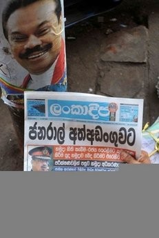A Sri Lankan man reads a newspaper report on the arrest of Sri Lankan former army chief and defeated presidential candidate Sarath Fonseka (poster) in Colombo on February 9, 2010. A Sri Lankan man reads a newspaper report on the arrest of Sri Lankan former army chief and defeated presidential candidate Sarath Fonseka (poster) in Colombo on February 9, 2010.