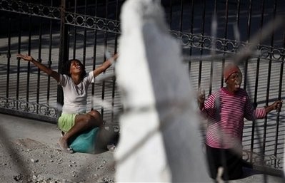 Two women pray outside the National Cathedral in Port-au-Prince, Monday, Feb. 8, 2010. Thousands were killed and many displaced after Haiti's Jan. 12 powerful earthquake Two women pray outside the National Cathedral in Port-au-Prince, Monday, Feb. 8, 2010. Thousands were killed and many displaced after Haiti's Jan. 12 powerful earthquake