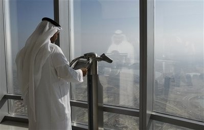 In this Jan. 4, 2010 file photo, an Emirati man looks over the city view at an observation point screen at the observation deck of the Burj Dubai tower, on Level 124 in Dubai, United Arab Emirates. In this Jan. 4, 2010 file photo, an Emirati man looks over the city view at an observation point screen at the observation deck of the Burj Dubai tower, on Level 124 in Dubai, United Arab Emirates.