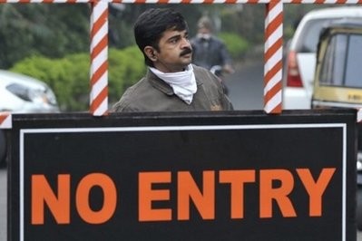 An Indian man stands behind a 'no entry' sign near the scene of blast in Pune on February 14. (AFP Photo) An Indian man stands behind a 'no entry' sign near the scene of blast in Pune on February 14. (AFP Photo)