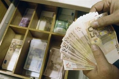 A teller counts euro banknotes inside a National Bank of Greece branch in Athens February 10, 2010. A teller counts euro banknotes inside a National Bank of Greece branch in Athens February 10, 2010.
