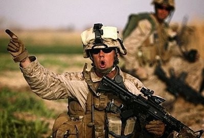 A US 1/3 Marine Weapons Company officer issues orders as marines advance against Taliban on the northeast of Marjah. A US 1/3 Marine Weapons Company officer issues orders as marines advance against Taliban on the northeast of Marjah.