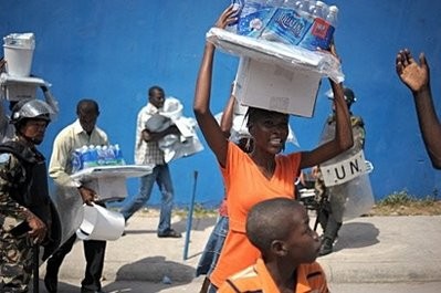 Haitians get tarps, water, and kitchen sets in Port-au-Prince. Haitians get tarps, water, and kitchen sets in Port-au-Prince.