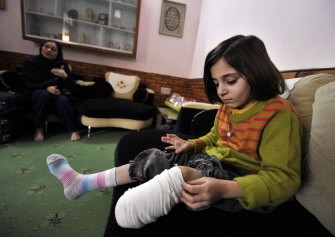 Seven year-old disabled Pakistan girl Laiba adjusts the bandage on her left leg as she sits on the sofa in the living room of her home at Hayatabad, a posh sector of the northwestern city of Peshawar on January 22, 2010. AFP photo Seven year-old disabled Pakistan girl Laiba adjusts the bandage on her left leg as she sits on the sofa in the living room of her home at Hayatabad, a posh sector of the northwestern city of Peshawar on January 22, 2010. AFP photo