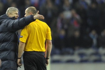 Arsenal coach Arsene Wenger (L) argues with Swedish referee Martin Hansson during their UEFA Champions League football match at the Dragao Stadium in Porto, on february 17, 2010. AFP photo Arsenal coach Arsene Wenger (L) argues with Swedish referee Martin Hansson during their UEFA Champions League football match at the Dragao Stadium in Porto, on february 17, 2010. AFP photo
