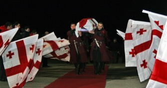 A Georgian honor guard carries the coffin of late Georgian luger Nodar Kumaritashvili, at the Tbilisi airport early on January 17, 2010. AFP photo A Georgian honor guard carries the coffin of late Georgian luger Nodar Kumaritashvili, at the Tbilisi airport early on January 17, 2010. AFP photo