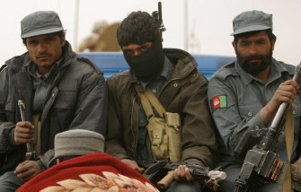 Afghan National Police officers sit in the back of a police pickup truck in Trikh Nawar in the northeastern outskirts of Marjah on February 22, 2010. AFP photo Afghan National Police officers sit in the back of a police pickup truck in Trikh Nawar in the northeastern outskirts of Marjah on February 22, 2010. AFP photo