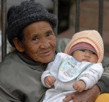 (AFP file) An elderly woman cares for her infant grand-daughter at a market in the mountain town of Sagada, the Philippines. (AFP file) An elderly woman cares for her infant grand-daughter at a market in the mountain town of Sagada, the Philippines.
