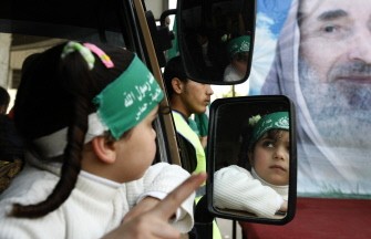 A Palestinian girl wearing a Hamas head band sit with her family near a giant portrait of later spiritual leader of HAMAS Sheikh Ahmed Yassin during a rally against Israel’s house demolitions, excavations near holy Muslim sites and settlement policy in Jerusalem, on February 19, 2010 in Gaza City . AFP photo A Palestinian girl wearing a Hamas head band sit with her family near a giant portrait of later spiritual leader of HAMAS Sheikh Ahmed Yassin during a rally against Israel’s house demolitions, excavations near holy Muslim sites and settlement policy in Jerusalem, on February 19, 2010 in Gaza City . AFP photo