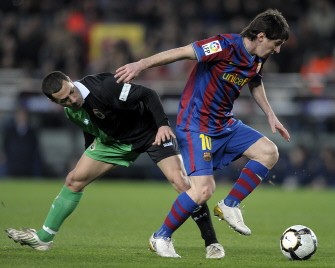 Barcelona's Argentinian forward Lionel Messi (R) vies with Racing Santander's French midfielder Mehdi Lacen during a Spanish League football match at the Camp Nou Stadium in Barcelona, on February 20, 2010. AFP PHOTO Barcelona's Argentinian forward Lionel Messi (R) vies with Racing Santander's French midfielder Mehdi Lacen during a Spanish League football match at the Camp Nou Stadium in Barcelona, on February 20, 2010. AFP PHOTO