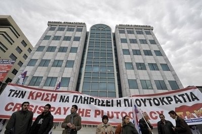 Members of the communist-affiliated PAME labour union block the entrance to the Athens Stock Exchange with a banner reading 'Crisis pay the plutocracy. Members of the communist-affiliated PAME labour union block the entrance to the Athens Stock Exchange with a banner reading 'Crisis pay the plutocracy.