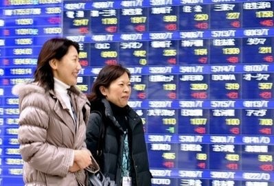 Pedestrians walk past a share prices board in Tokyo. A surprise move by the US Federal Reserve to hike one of its lending rates triggered fears in Asian markets Friday that global stimulus measures may begin unwinding sooner than expected. Pedestrians walk past a share prices board in Tokyo. A surprise move by the US Federal Reserve to hike one of its lending rates triggered fears in Asian markets Friday that global stimulus measures may begin unwinding sooner than expected.
