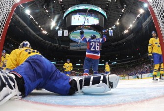 Swedish goalkeeper Henrik Lundqvist (30) misses the puck as Slovakian forward Michal Handzus (26) celebrates a goal in Vancouver, Canada on February 24, 2010. Slovakia won 4-3. AFP PHOTO Swedish goalkeeper Henrik Lundqvist (30) misses the puck as Slovakian forward Michal Handzus (26) celebrates a goal in Vancouver, Canada on February 24, 2010. Slovakia won 4-3. AFP PHOTO
