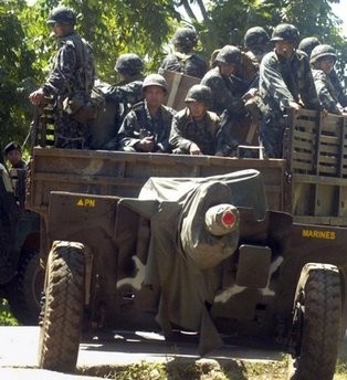 Philippine troops are seen passing through a town in the restive southern Philippine island of Jolo. (AFP Photo) Philippine troops are seen passing through a town in the restive southern Philippine island of Jolo. (AFP Photo)