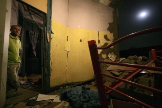 A man stands in the doorway of his home damaged by the 8.8 magnitude earthquake earlier in the day in Santiago on February 27, 2010 in a district where many Peruvian immigrants live. AFP photo A man stands in the doorway of his home damaged by the 8.8 magnitude earthquake earlier in the day in Santiago on February 27, 2010 in a district where many Peruvian immigrants live. AFP photo