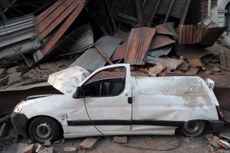 A damaged car is pictured next to rubble in Curico, 250 km south of Santiago on February 27, 2010. AFP photo A damaged car is pictured next to rubble in Curico, 250 km south of Santiago on February 27, 2010. AFP photo