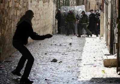 A Palestinian youth throws stones at Israeli soldiers and policemen during clashes near the Al-Aqsa mosque compound in Jerusalem's old city on February 28, 2010 A Palestinian youth throws stones at Israeli soldiers and policemen during clashes near the Al-Aqsa mosque compound in Jerusalem's old city on February 28, 2010