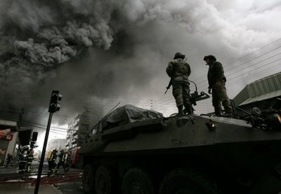 Soldiers stand guard as firemen fight a fire at a supermarket in Concepcion, Chile, three days after a huge 8.8-magnitude earthquake rocked the country killing at least 711 people. Soldiers stand guard as firemen fight a fire at a supermarket in Concepcion, Chile, three days after a huge 8.8-magnitude earthquake rocked the country killing at least 711 people.