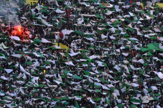 Algerian supporters hold up national flags and cheer their national football team against Serbia during their friendly football match on March 3, 2010 in Algiers. Serbia won the match 3-0. AFP PHOTO Algerian supporters hold up national flags and cheer their national football team against Serbia during their friendly football match on March 3, 2010 in Algiers. Serbia won the match 3-0. AFP PHOTO
