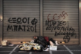 A homeless man sleeps outside a closed bank in central Athens on March 23, 2010. AFP photo A homeless man sleeps outside a closed bank in central Athens on March 23, 2010. AFP photo