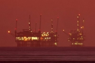 Offshore oil rigs are seen at night near Santa Barbara, California Offshore oil rigs are seen at night near Santa Barbara, California
