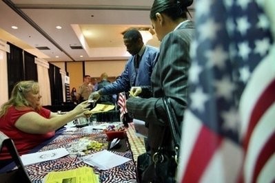 Job seekers talk to a recruiter at a career fair in Ontario, California Job seekers talk to a recruiter at a career fair in Ontario, California
