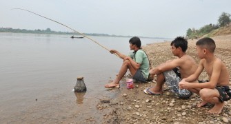 Men sit fishing on a bank of the drought-hit Mekong River at Hom village in the suburds of Vientiane on March 27, 2010. AFP photo Men sit fishing on a bank of the drought-hit Mekong River at Hom village in the suburds of Vientiane on March 27, 2010. AFP photo