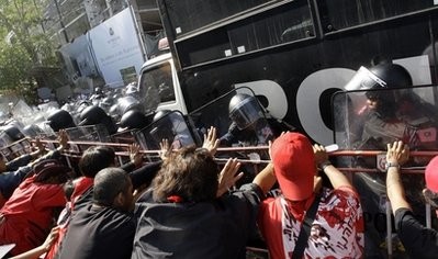 Anti-government protesters use barriers to push back riot policemen during a demonstration in Bangkok, Thailand, Tuesday, April 6, 2010. Anti-government protesters use barriers to push back riot policemen during a demonstration in Bangkok, Thailand, Tuesday, April 6, 2010.