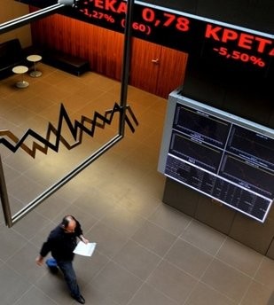 An employee walks through the Athens stock exchange. AFP photo An employee walks through the Athens stock exchange. AFP photo