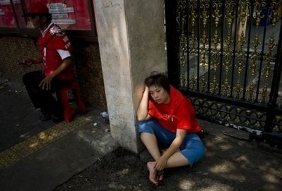 A protestor rests on the street after overnight clashes between the army and Red Shirt demonstrators in central Bangkok. A protestor rests on the street after overnight clashes between the army and Red Shirt demonstrators in central Bangkok.