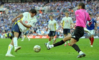 Tottenham Hotspur's Vedran Corluka (L) shoots as Portsmouth's goalkeeper David James (R) blocks during the FA Cup semi-final football match between Tottenham Hotspur and Portsmouth at Wembley Stadium on April 11, 2010. AFP PHOTO Tottenham Hotspur's Vedran Corluka (L) shoots as Portsmouth's goalkeeper David James (R) blocks during the FA Cup semi-final football match between Tottenham Hotspur and Portsmouth at Wembley Stadium on April 11, 2010. AFP PHOTO