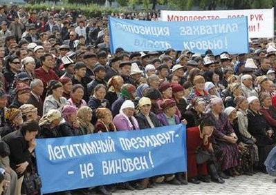 Supporters of the ousted President Kurmanbek Bakiyev hold posters at a rally in the centre of Jalalabad, April 13, 2010. Supporters of the ousted President Kurmanbek Bakiyev hold posters at a rally in the centre of Jalalabad, April 13, 2010.