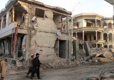 Afghans walk past the site of an explosion in Kandahar in southern Afghanistan on April 16. British and military officials were Friday investigating reports that security contractors from Britain were among the victims of a suicide car bombing in volatile southern Afghanistan Afghans walk past the site of an explosion in Kandahar in southern Afghanistan on April 16. British and military officials were Friday investigating reports that security contractors from Britain were among the victims of a suicide car bombing in volatile southern Afghanistan