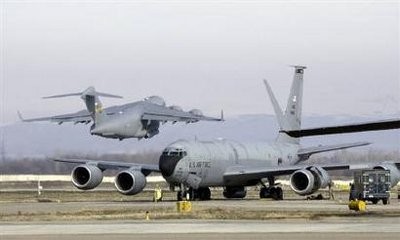 C-17 Globemaster takes off past a KC-135 Stratotanker at Manas Air Base near Kyrgyzstan's capital Bishkek, February 13, 2009. C-17 Globemaster takes off past a KC-135 Stratotanker at Manas Air Base near Kyrgyzstan's capital Bishkek, February 13, 2009.
