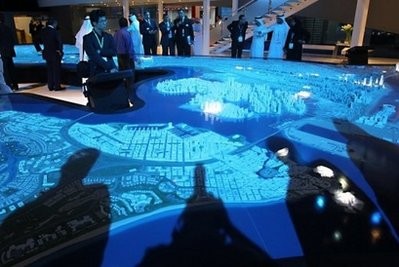 Visitors look at a model of the Capital City District project displayed at the Cityscape exhibition in the Emirati capital Abu Dhabi. Visitors look at a model of the Capital City District project displayed at the Cityscape exhibition in the Emirati capital Abu Dhabi.