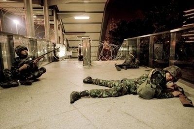 A Thai armed soldier takes up position on a walkway at the entrance to Silom road in the financial district of Bangkok. A Thai armed soldier takes up position on a walkway at the entrance to Silom road in the financial district of Bangkok.