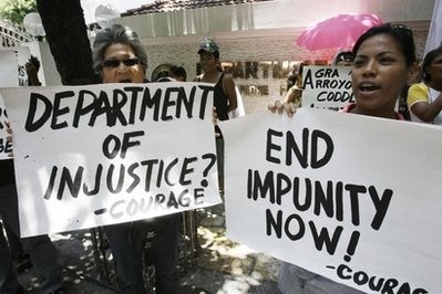 Protesters display their placards as they shout slogans during a rally at the Department of Justice Tuesday, April 20, 2010 in Manila, Philippines. Protesters display their placards as they shout slogans during a rally at the Department of Justice Tuesday, April 20, 2010 in Manila, Philippines.