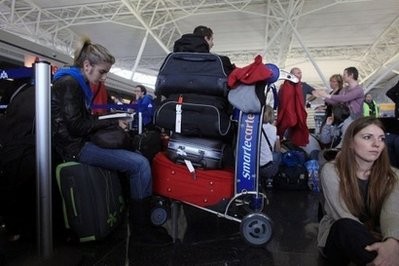 Stranded travelers trying to get back to Brussels wait in line at John F. Kennedy Airport in New York. Stranded travelers trying to get back to Brussels wait in line at John F. Kennedy Airport in New York.