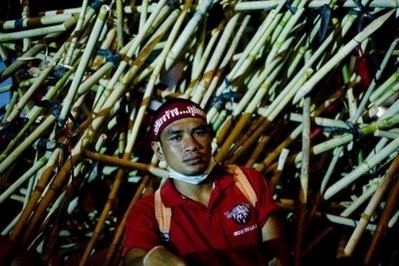 Red Shirt anti-government protester pictured next to bamboo barricades set up in Bangkok's financial district, during a protest on April 21. Red Shirt anti-government protester pictured next to bamboo barricades set up in Bangkok's financial district, during a protest on April 21.