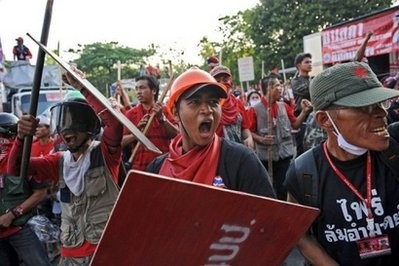Red Shirt anti-government protesters are seen next to their barricades during a face-off with riot police at the Silom road intersection, in central Bangkok's financial district early on April 23 Red Shirt anti-government protesters are seen next to their barricades during a face-off with riot police at the Silom road intersection, in central Bangkok's financial district early on April 23